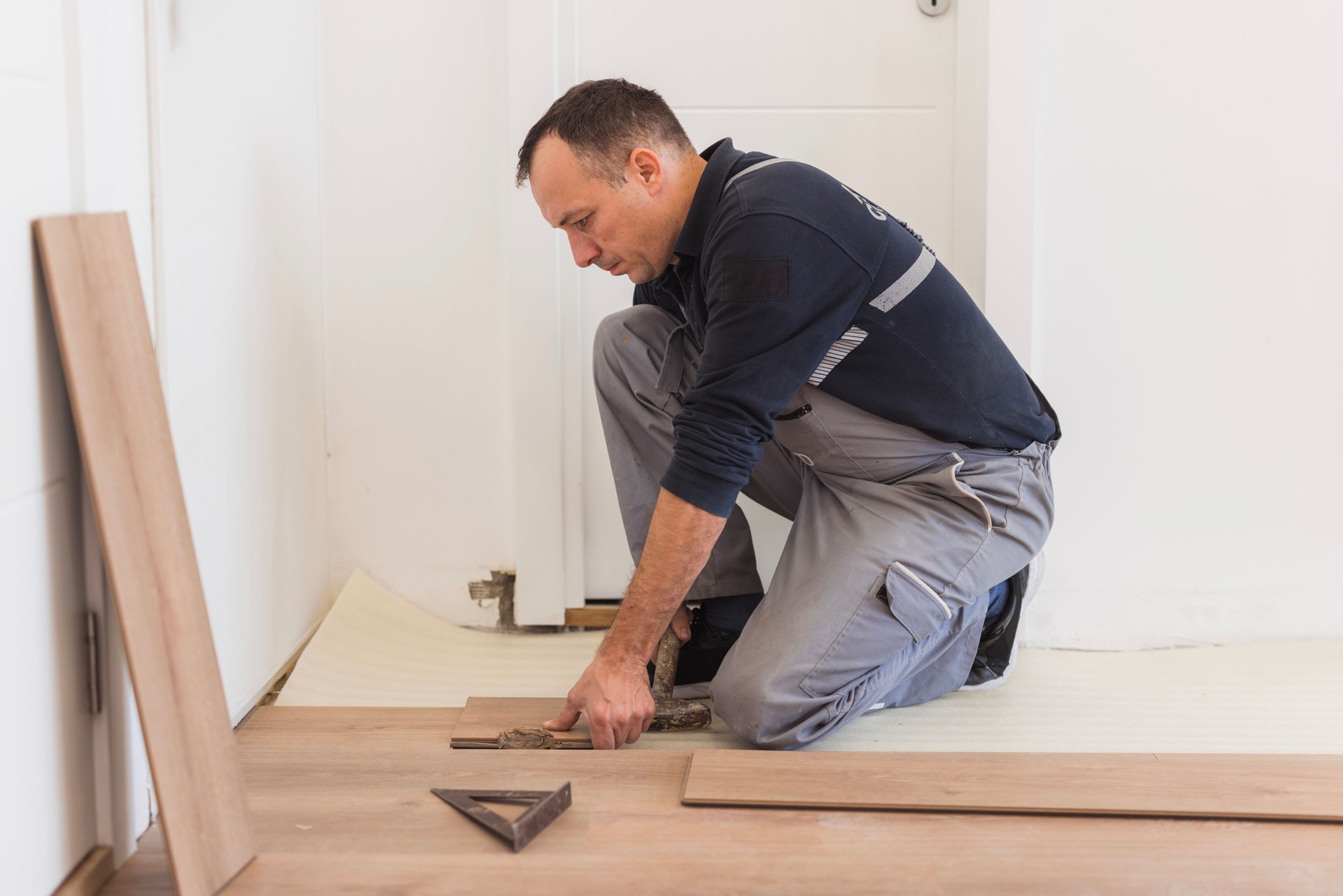 Handyman using tool during floor installment